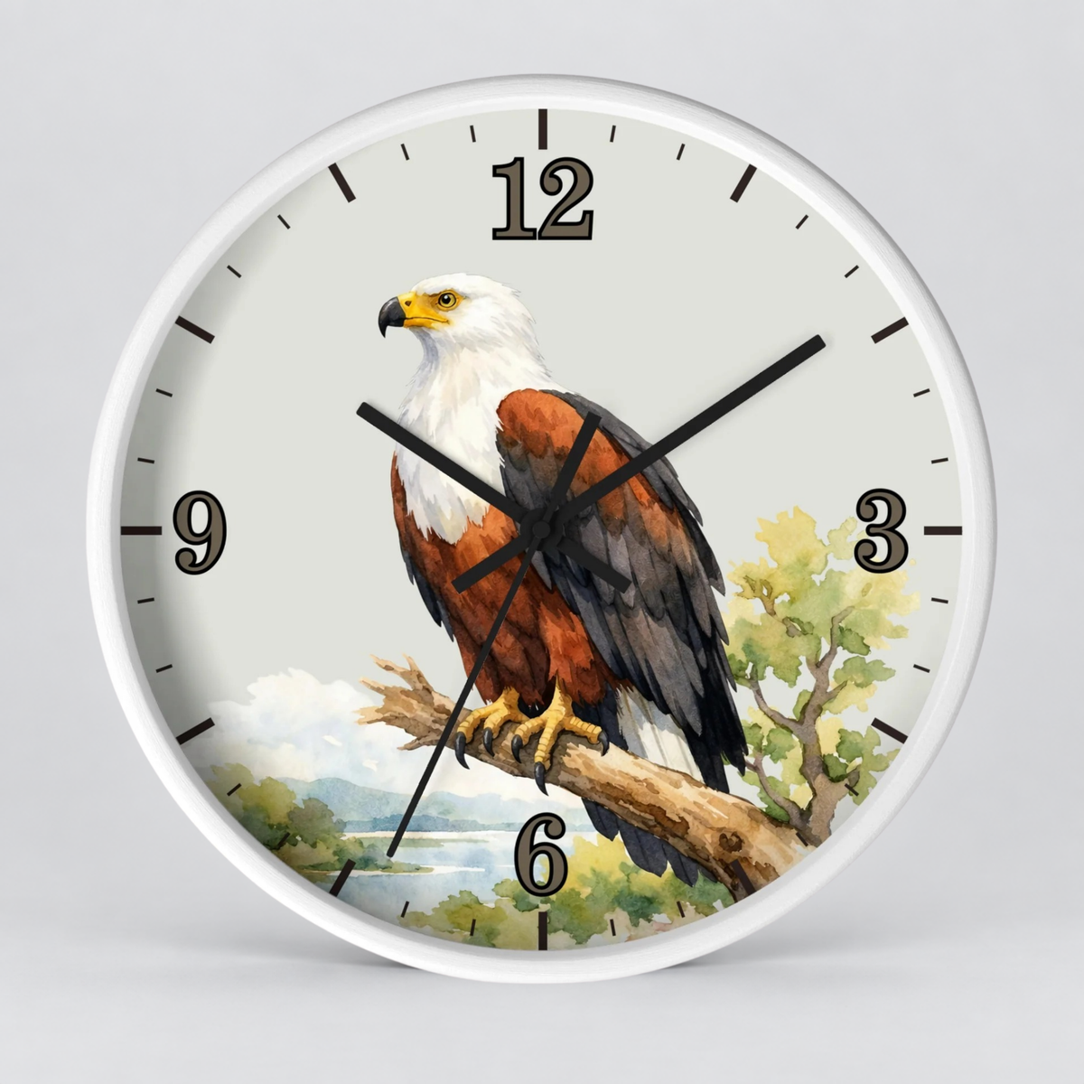 A round wall clock with a white frame and a printed bird illustration on the face. The design shows a large eagle perched on a branch, with black Arabic numerals and black clock hands on a light gray background.