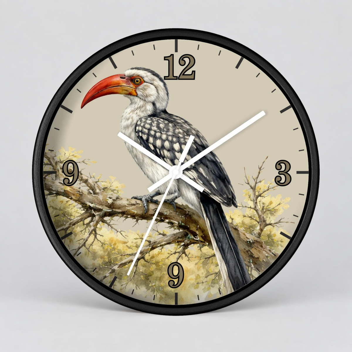 A round wall clock with a black frame and a printed bird illustration on the face. The clock shows a white and gray bird with a bright red beak perched on a branch against a light beige background, with black numerals and white clock hands.