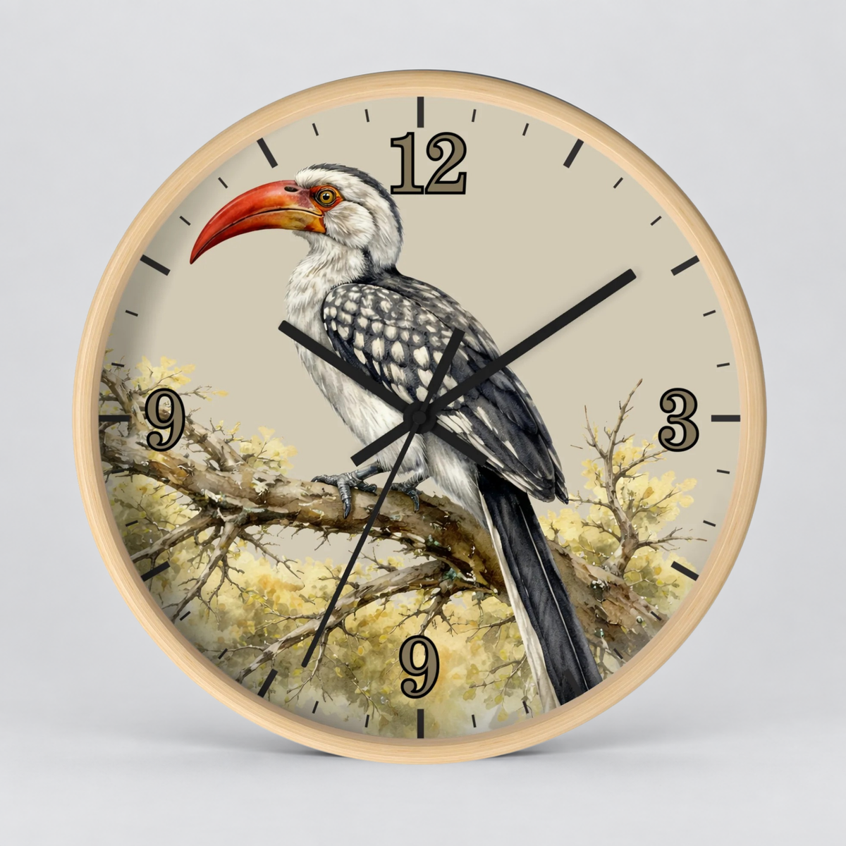 A round wall clock with a light wood frame and a printed bird illustration. The clock face features a detailed painting of a hornbill perched on a branch, with black Arabic numerals and black clock hands against a light beige background.