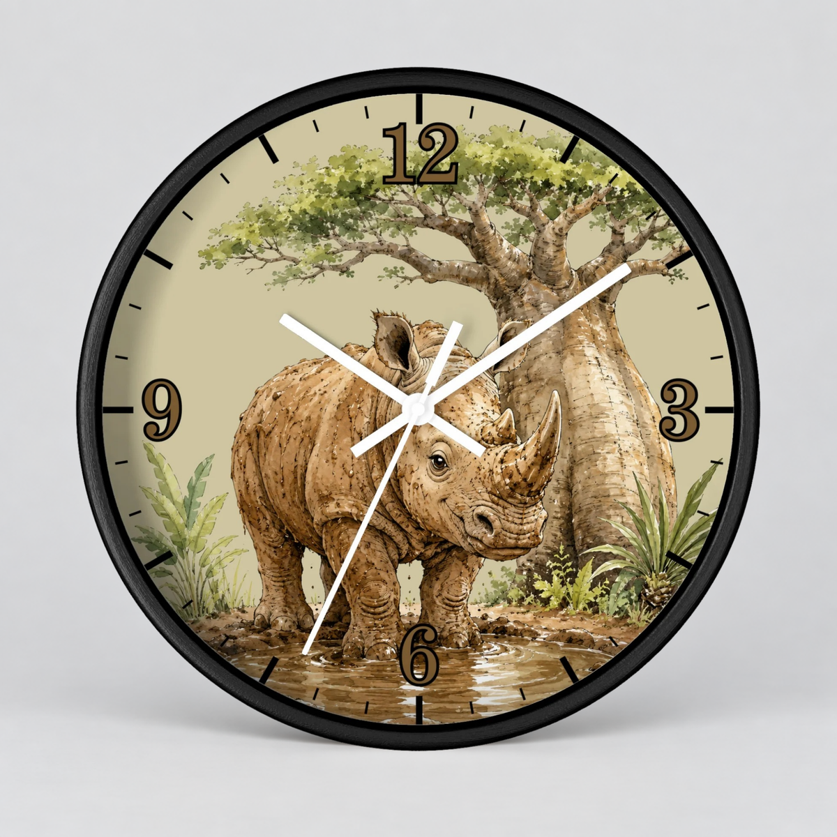 A round wall clock with a black frame and a safari-themed dial illustration featuring a rhinoceros, acacia tree, and watering scene. The clock has black Arabic numerals and white hands, photographed against a light gray background.