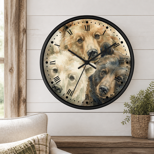 A round wall clock with a black frame and Roman numerals, featuring a printed illustration of three bear faces. The clock is mounted on a white shiplap wall above a wooden mantel with a small potted plant, and part of a beige armchair is visible in the lower left.