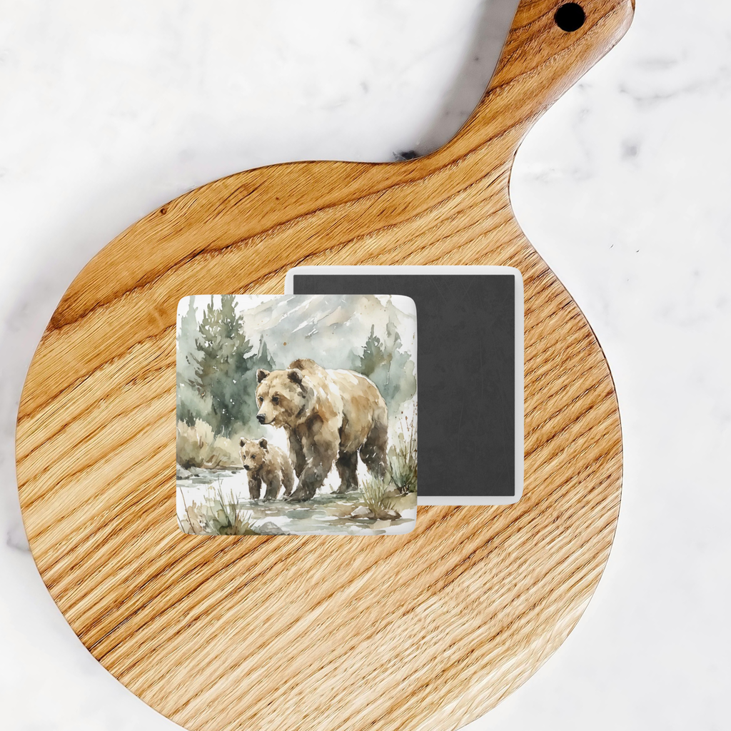 Two magnets with bear illustrations on a wooden cutting board.