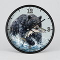 A round wall clock with a black frame and a printed illustration of a black bear carrying a fish across the face, with black Arabic numerals and clock hands on a light gray background.