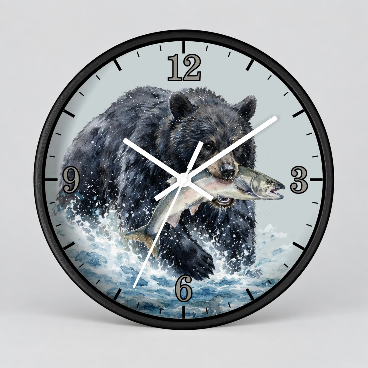 A round wall clock with a black frame and a printed design of a black bear catching a fish in splashing water, shown against a light gray background.