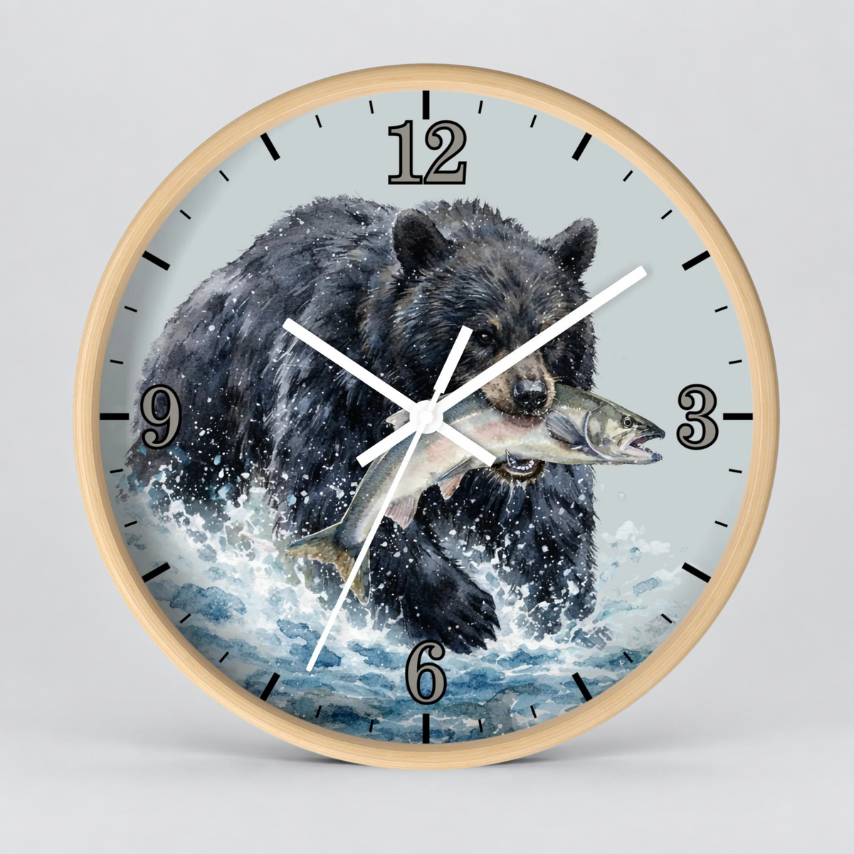 Round wall clock with a light wood frame and a printed illustration of a black bear catching a fish in splashing water, shown on a light gray background.