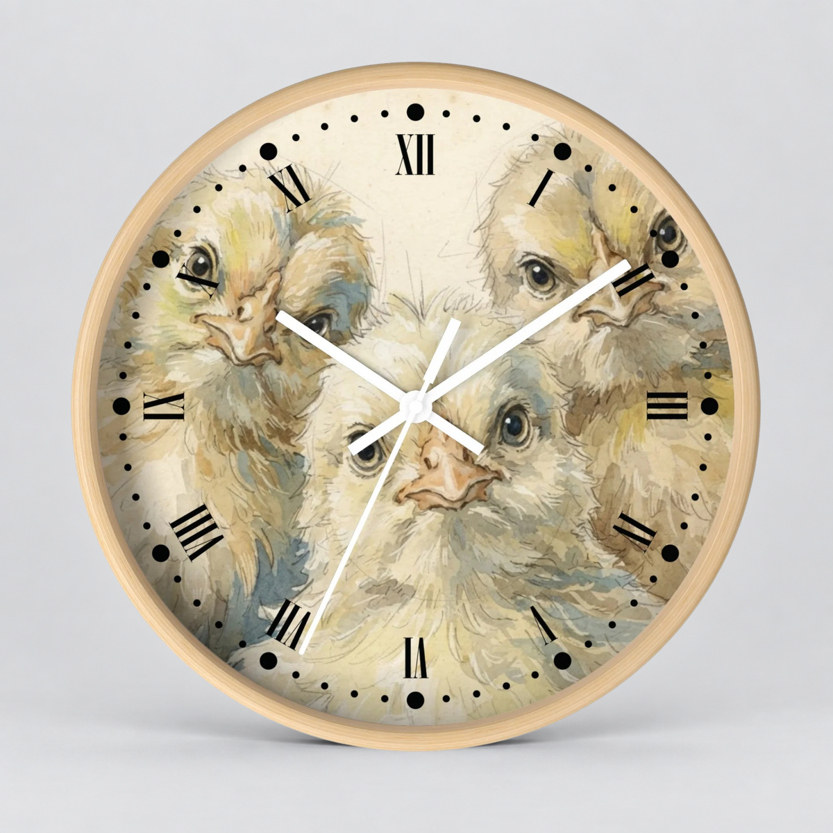 Round wall clock with a light wood frame and a printed illustration of four chicks on the face, with black Roman numerals and white clock hands, shown against a light gray background.