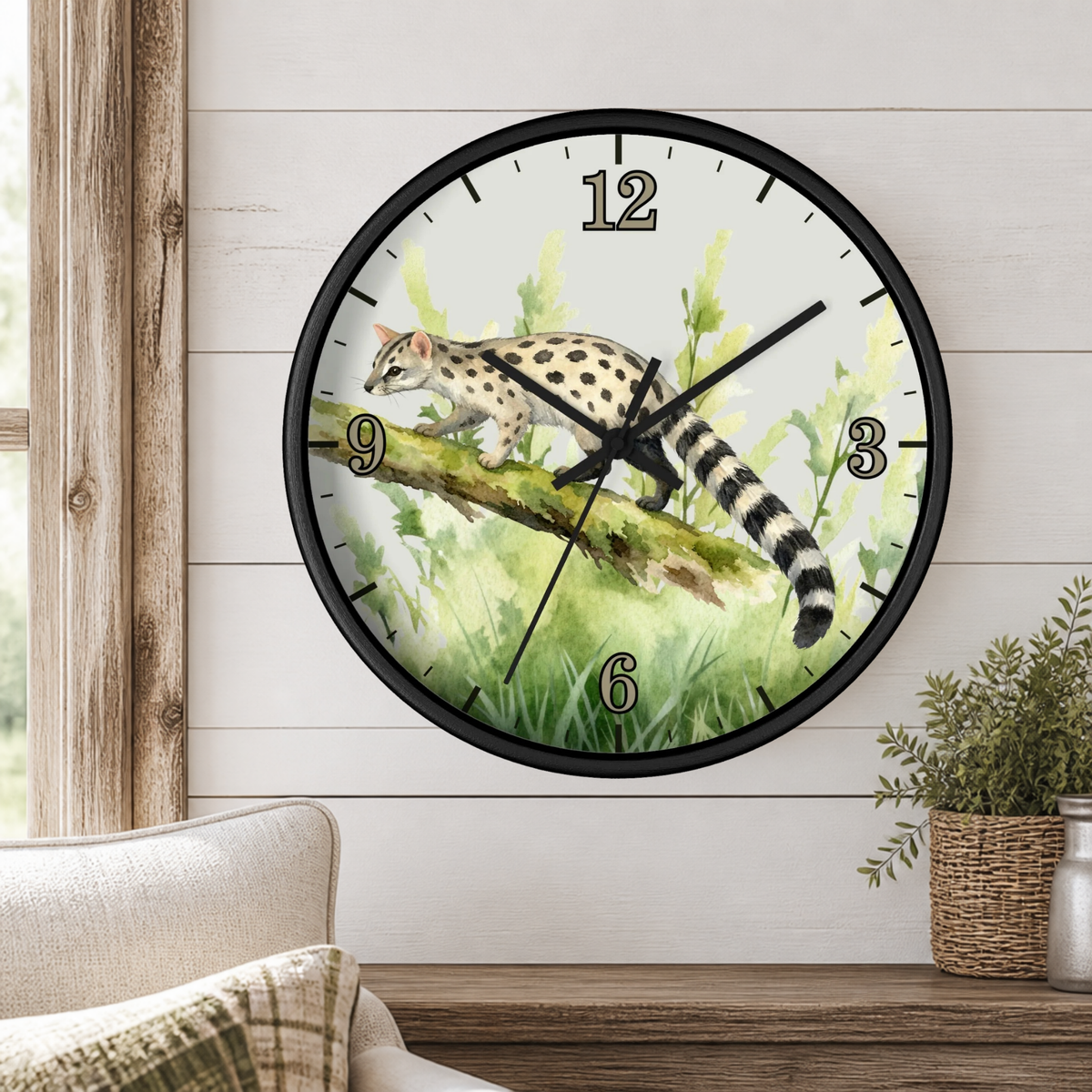 A round wall clock with a black frame and a printed illustration of a spotted cat on a branch among green plants, mounted on a white wood-paneled wall above a wooden shelf with a plant and part of a chair visible.
