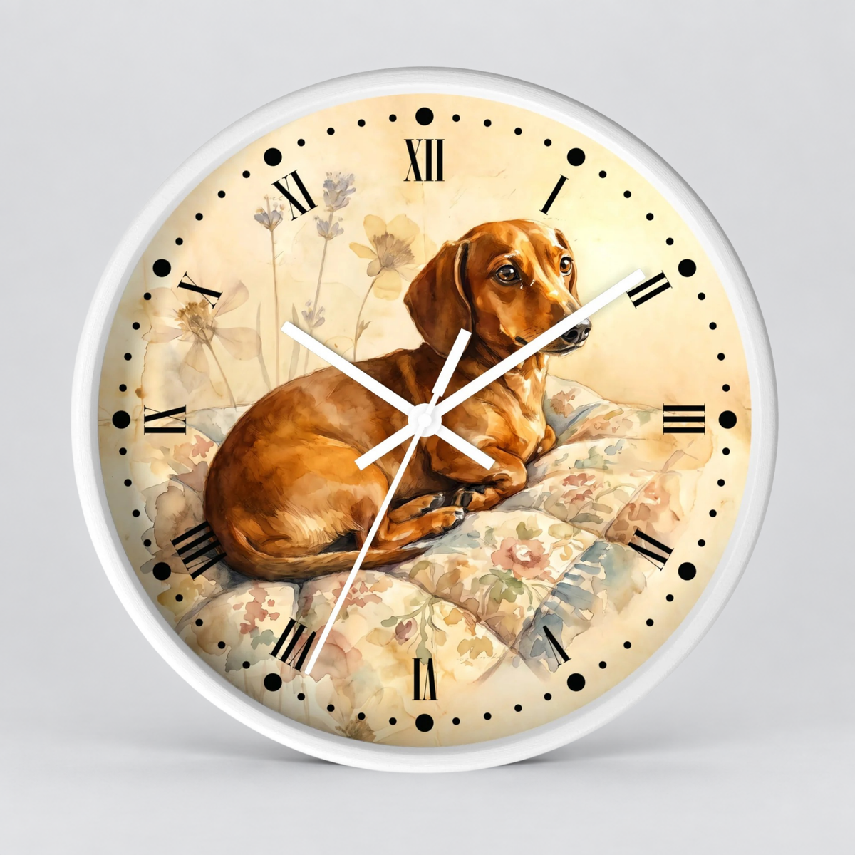 Round wall clock with a white frame and a printed dial showing a brown dachshund lying on a floral cushion, with black Roman numerals and white hands on a light gray background.