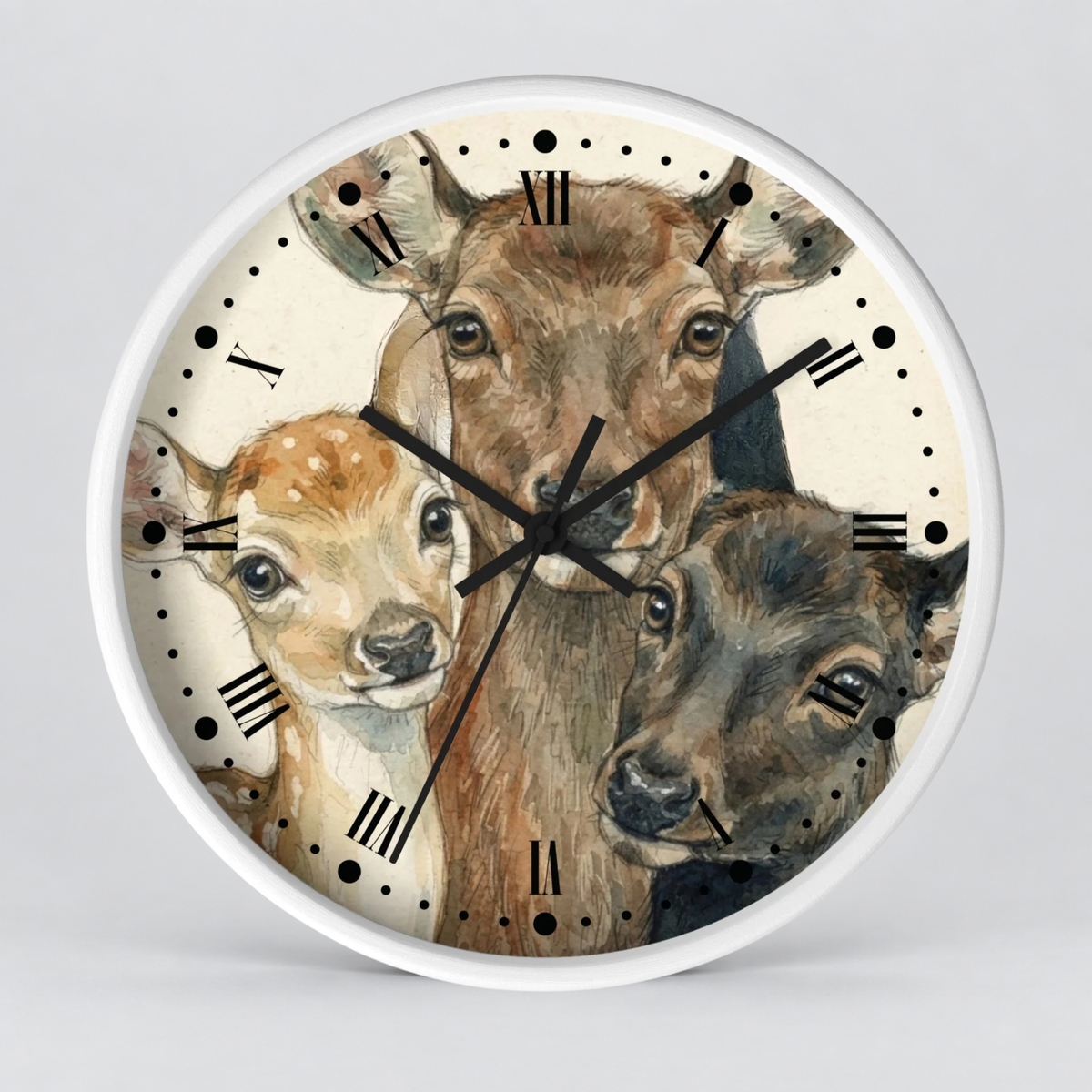 Round wall clock with a white frame and a printed illustration of three deer heads on the face, with black Roman numerals and black clock hands, shown against a light gray background.