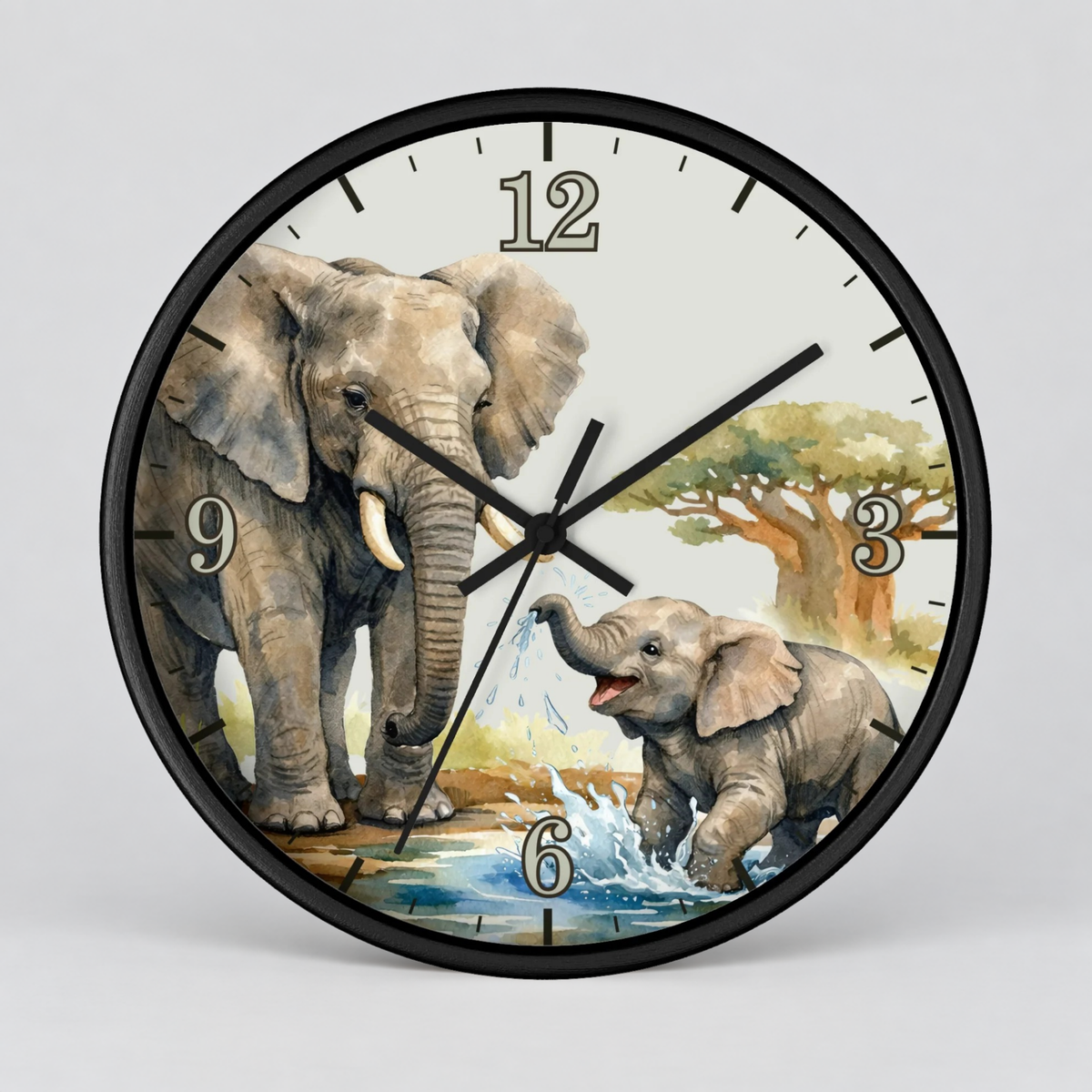 A round wall clock with a black frame and a printed safari scene featuring two elephants, a tree, and a watering hole on the dial, shown against a light gray background.