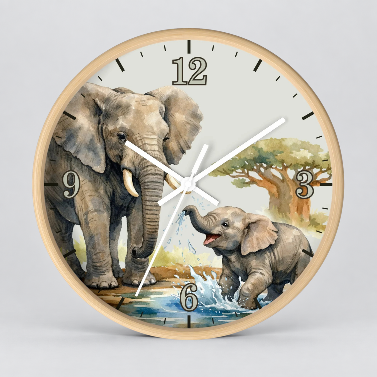 Round wall clock with a light wood frame and a printed elephant scene on the face, featuring two elephants, a tree, and black Arabic numerals, shown against a light gray background.