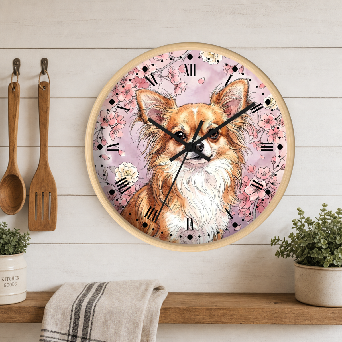 A round wall clock with a light wood frame hangs on a white wood-paneled wall above a shelf. The clock face features a detailed illustration of a fluffy long-haired dog surrounded by pink flowers and black Roman numerals.