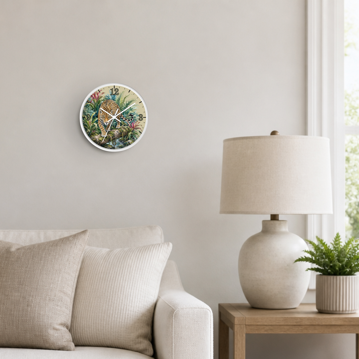 A round wall clock featuring a leopard walking in a jungle scene, mounted on a light beige wall above a sofa in a styled living room setting.
