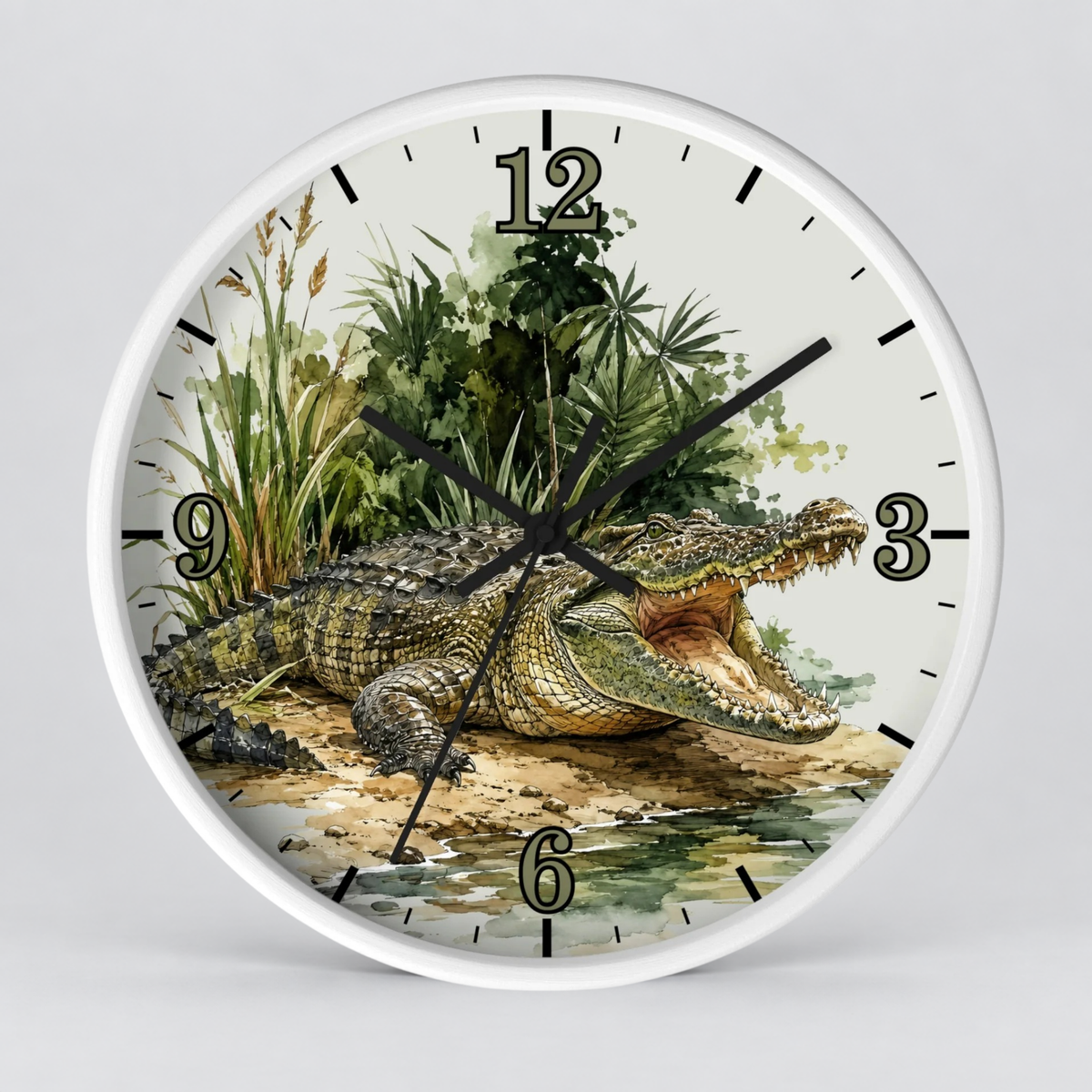 Round wall clock with a white frame and a printed illustration of an alligator on a riverbank with tropical plants, set against a light gray background.