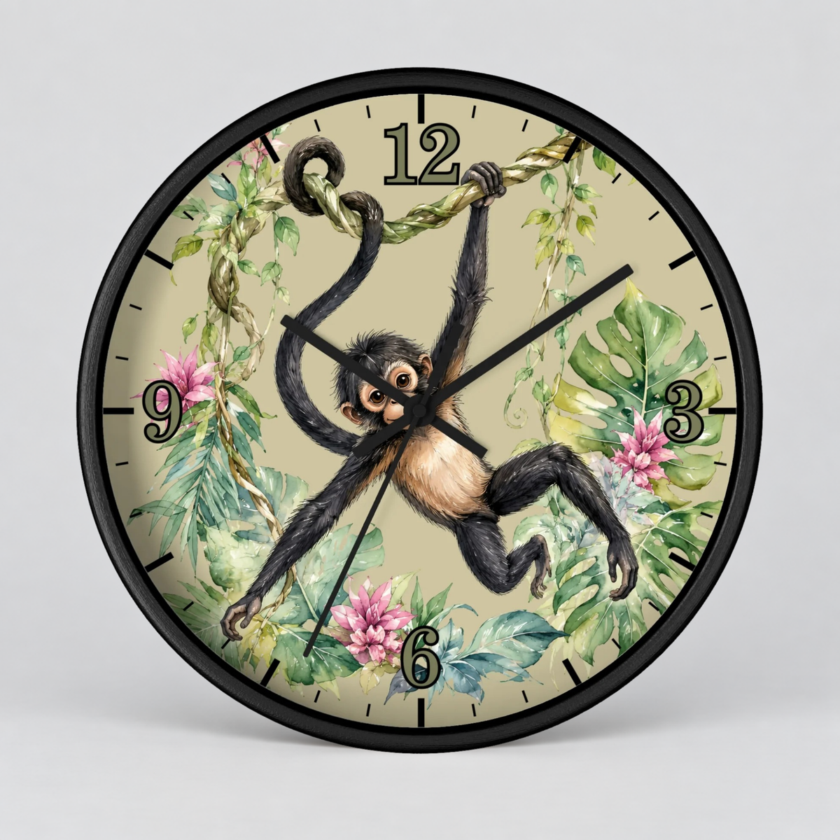 A round wall clock with a black frame and a tropical jungle illustration featuring a hanging spider monkey, green leaves, pink flowers, and beige background. The clock is shown against a neutral light gray background.