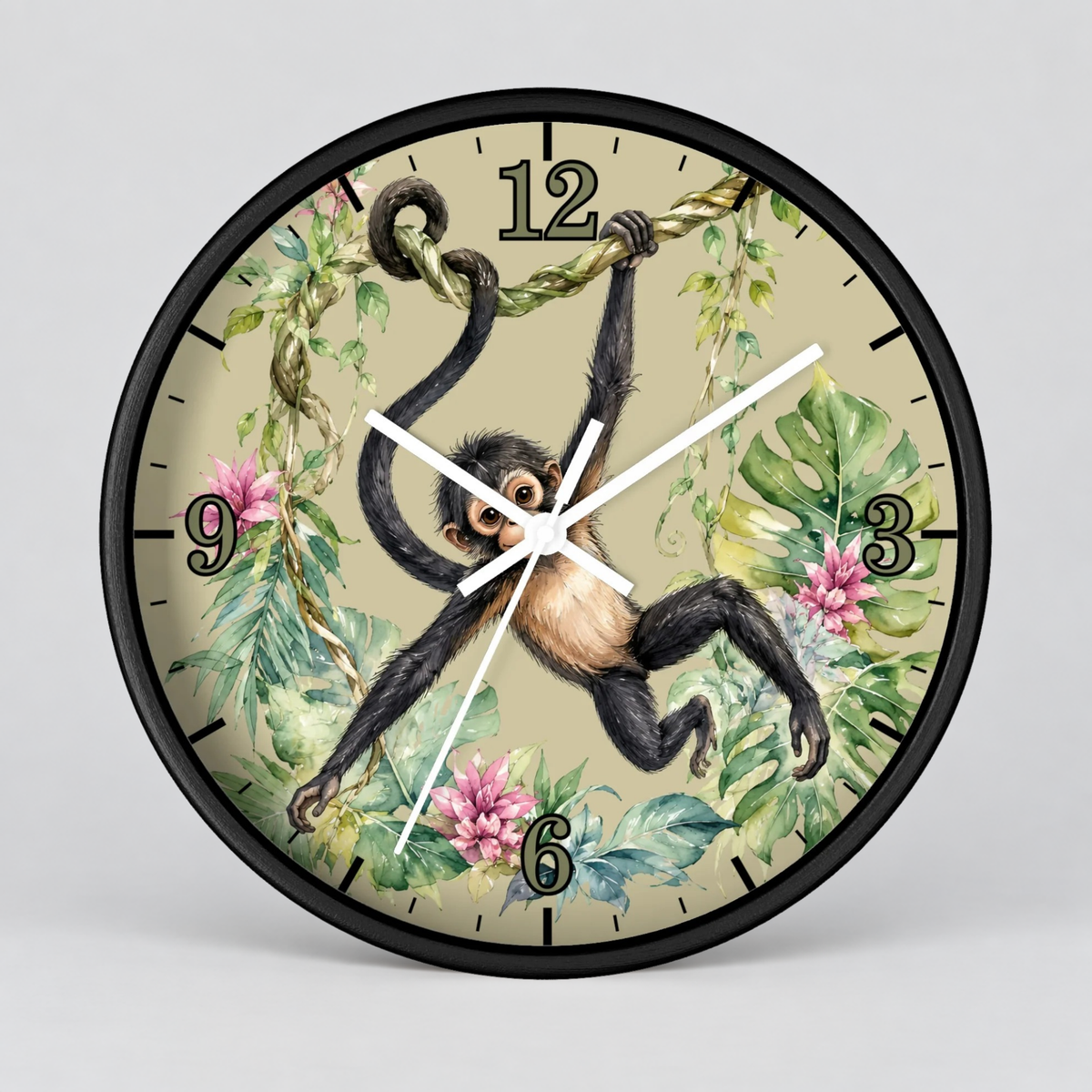 A round wall clock with a black frame and a tropical jungle illustration featuring a hanging spider monkey, green leaves, pink flowers, and beige background. The clock is shown against a neutral light gray background.