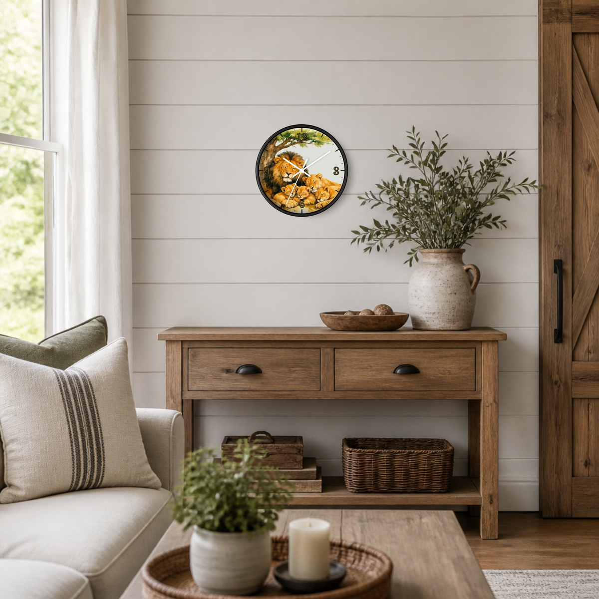 A round wall clock with a rustic wood-grain face and black frame hangs on a white shiplap wall above a wooden console table in a bright, modern farmhouse-style living room.