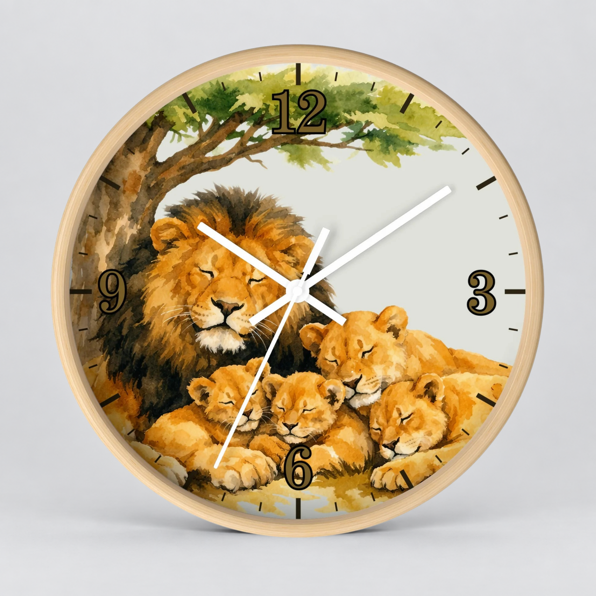 Round wall clock with a light wood frame and a watercolor-style illustration of a lion family under an acacia tree. The clock face is light gray with black Arabic numerals and white clock hands.