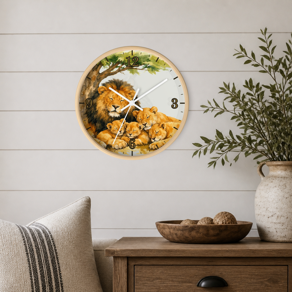 A round wall clock featuring a painted lion family scene, mounted on a white shiplap wall above a wooden side table with a vase and bowl.