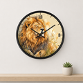 A round wall clock with a black frame and a printed lion illustration on the face, mounted on a light gray wall above a wooden shelf with a small potted succulent.