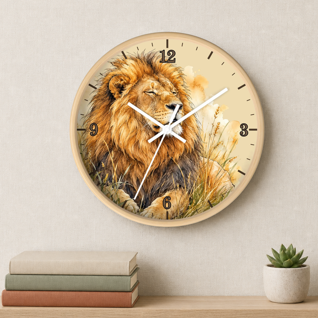 Round wall clock with a lion illustration on the face, mounted on a light beige wall above a shelf with stacked books and a small potted succulent.
