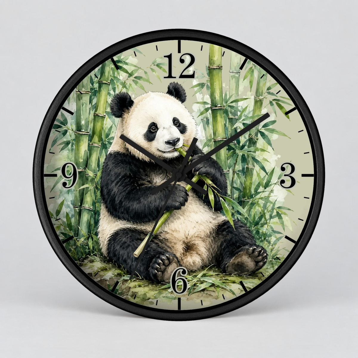 Round wall clock with a black frame and a printed panda sitting among bamboo on the clock face, shown against a light gray background.