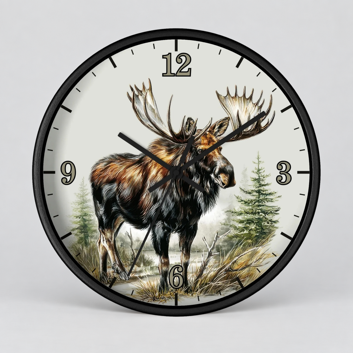 Round wall clock with a black frame and a printed moose illustration on the face, with black numerals and hands, shown against a light gray background.