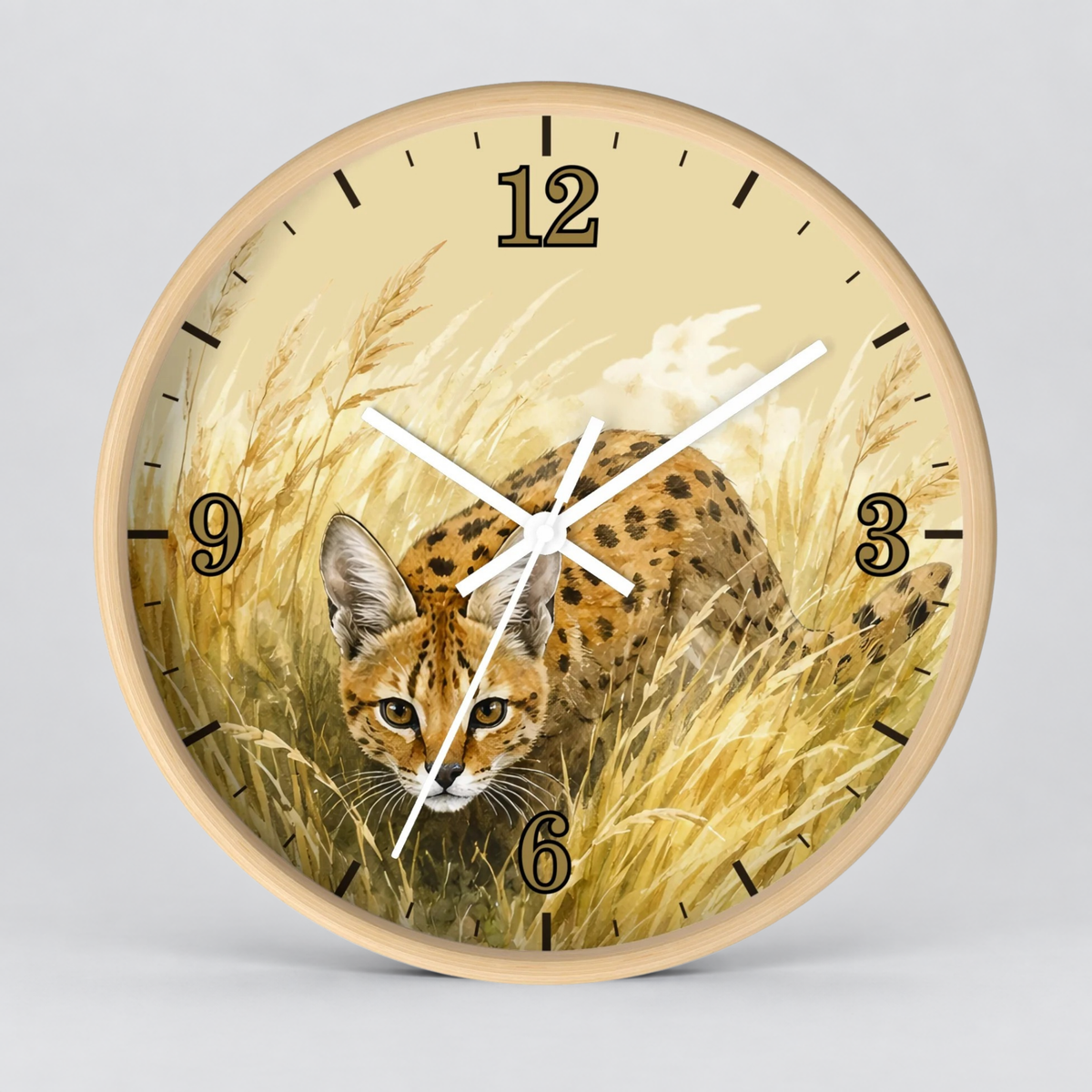 Round wall clock with a light wood frame and a printed design of a spotted big cat in tall golden grass, shown against a plain light gray background.