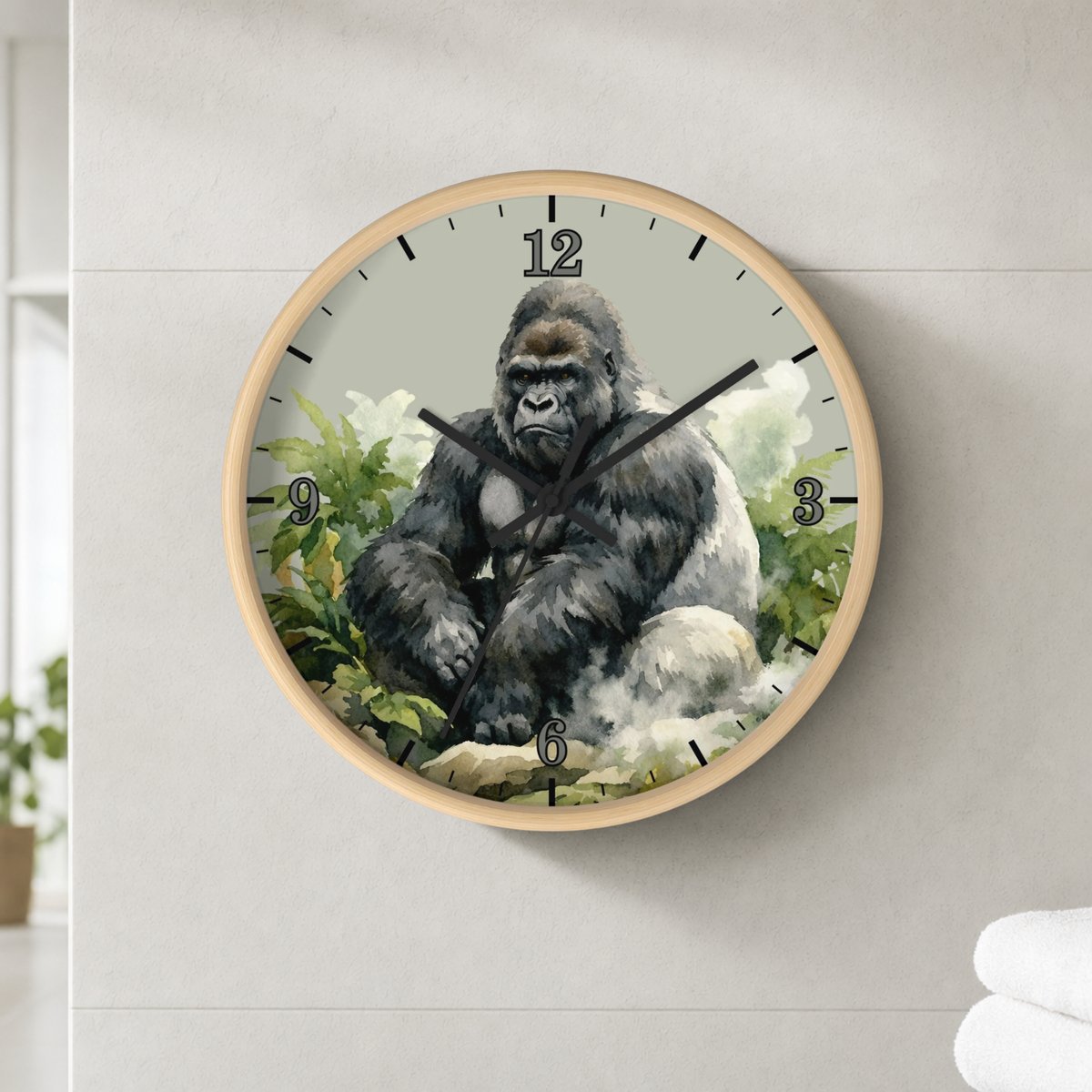 A round wall clock with a light wood frame featuring a detailed illustration of a seated gorilla on the clock face, mounted on a light gray tiled wall.