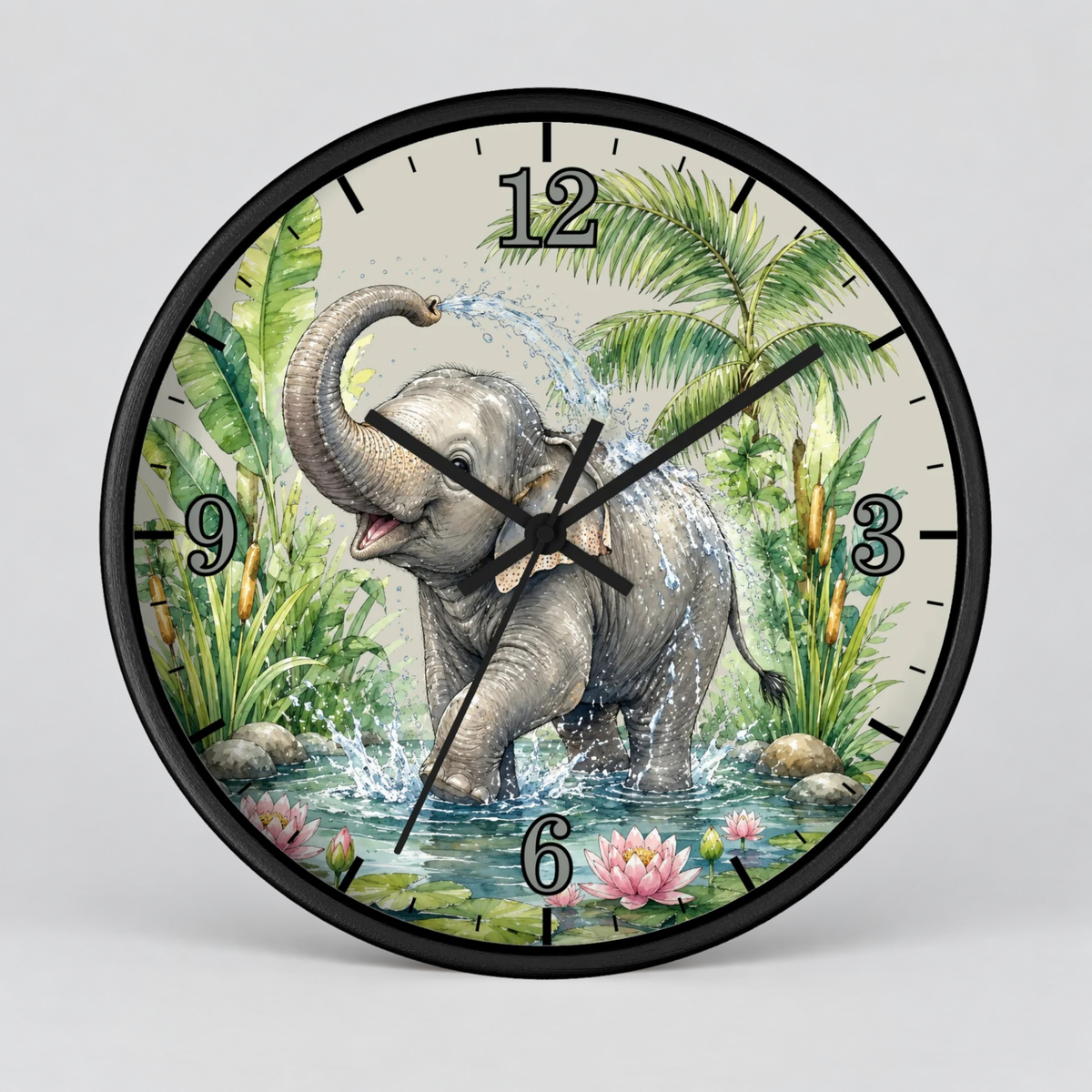 A round wall clock with a black frame and a printed illustration of a gray elephant standing in water among palm leaves and flowers. The clock face is light beige with black Arabic numerals and black clock hands, shown against a light gray background.