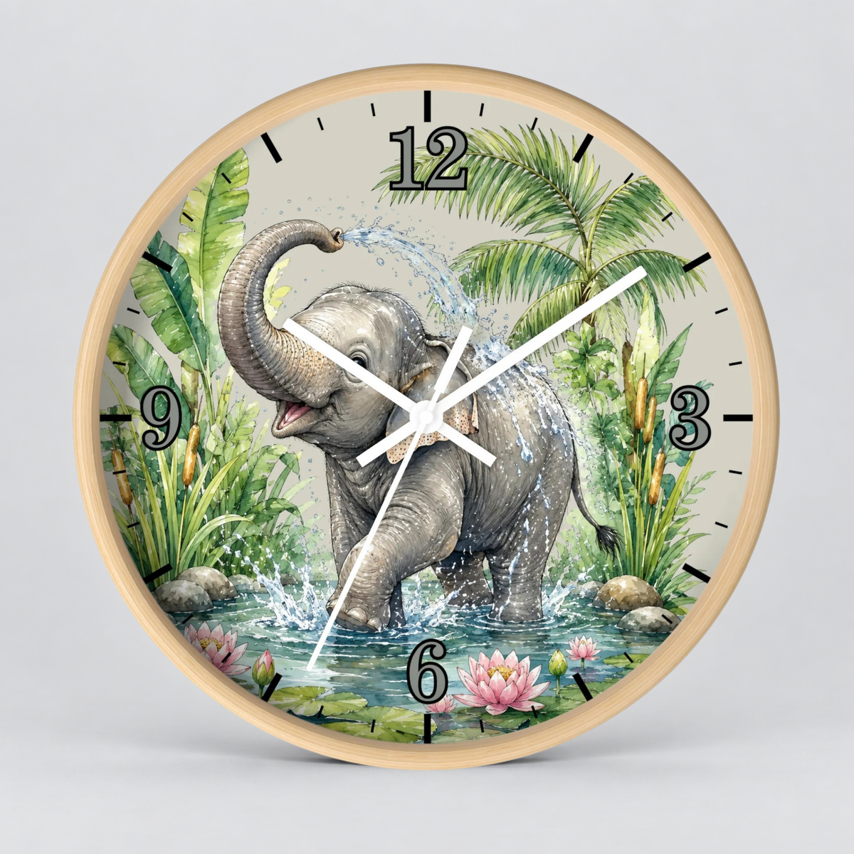 Round wall clock with a light wood frame and a tropical jungle illustration featuring a gray elephant standing in water, surrounded by palm leaves, lily pads, and pink flowers. The clock face has black Arabic numerals and white hands, photographed against a light gray background.