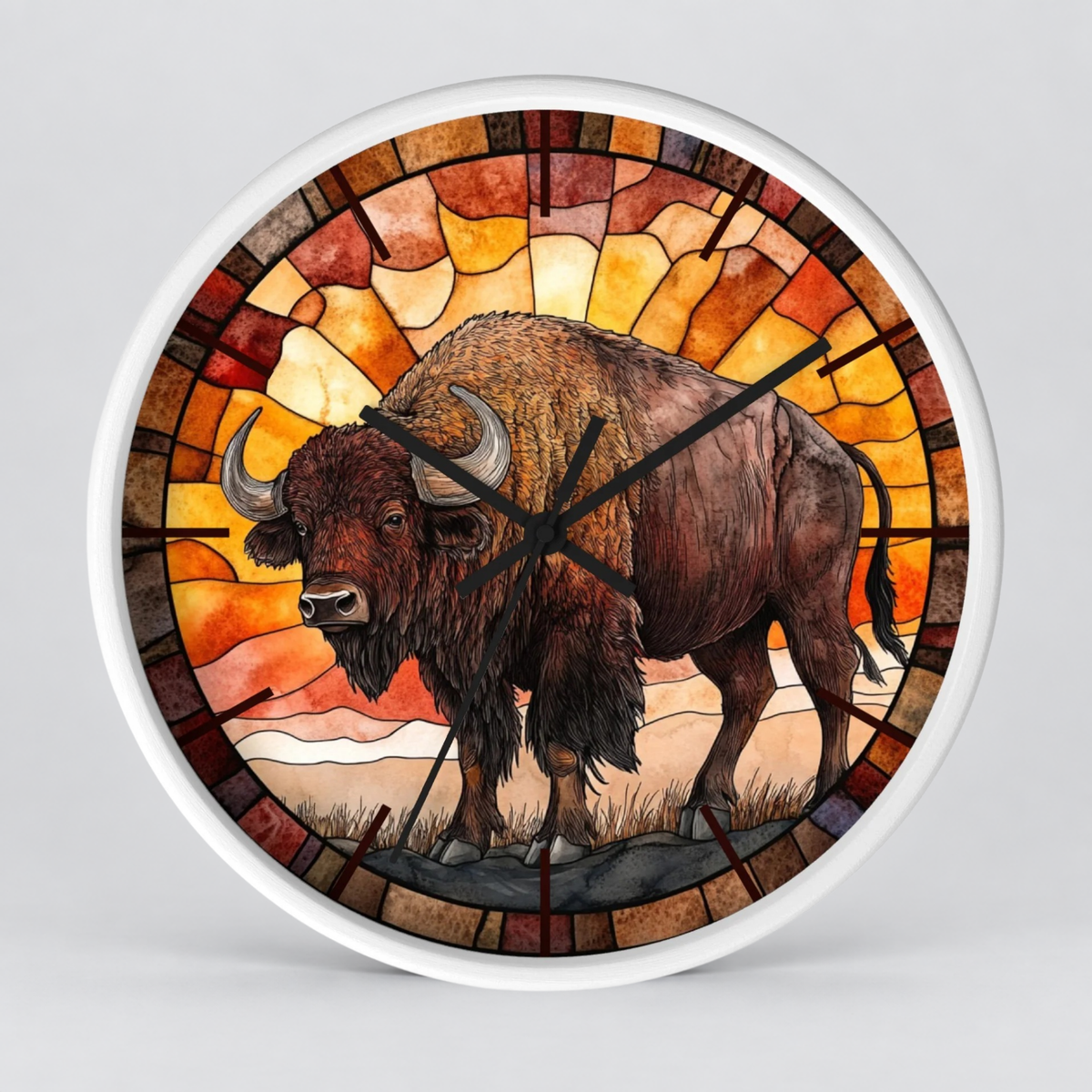 Round wall clock with a stained-glass-style design featuring a brown bison in the center, surrounded by warm orange, yellow, and red geometric panels, with black hands and a white outer rim.