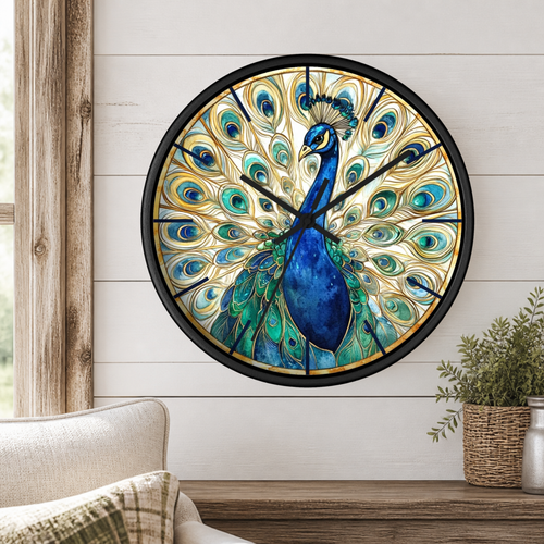 Round wall clock featuring a detailed peacock illustration with blue, teal, green, and gold feathers on a light background, mounted on a white shiplap wall above a wooden console table with a plant and chair.