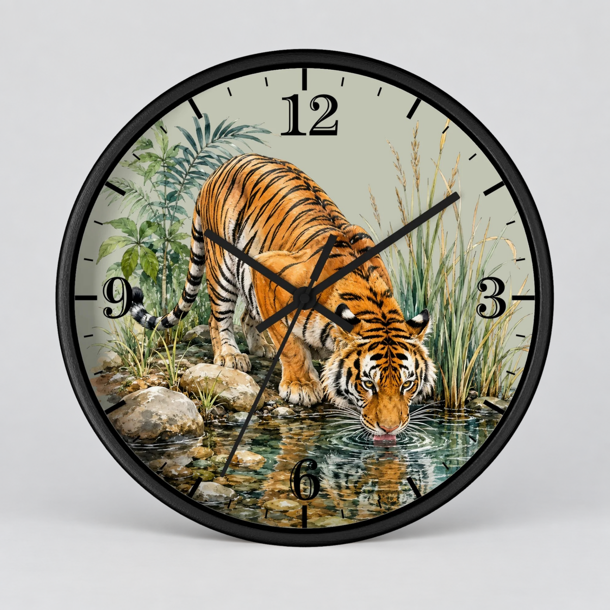 A round wall clock with a black frame and a printed illustration of a tiger drinking water from a stream, shown against a light gray background.