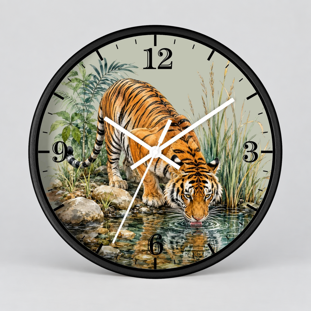 A round wall clock with a black frame and a printed illustration of a tiger drinking water from a stream. The clock face has black Arabic numerals and white hands, photographed against a light gray background.