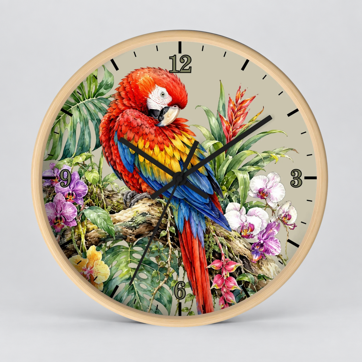 A round wall clock with a light wood frame and a tropical parrot illustration on the face. The clock features a red, yellow, and blue parrot perched among green leaves and purple flowers on a light beige background, with black numerals and hands, shown against a neutral gray background.