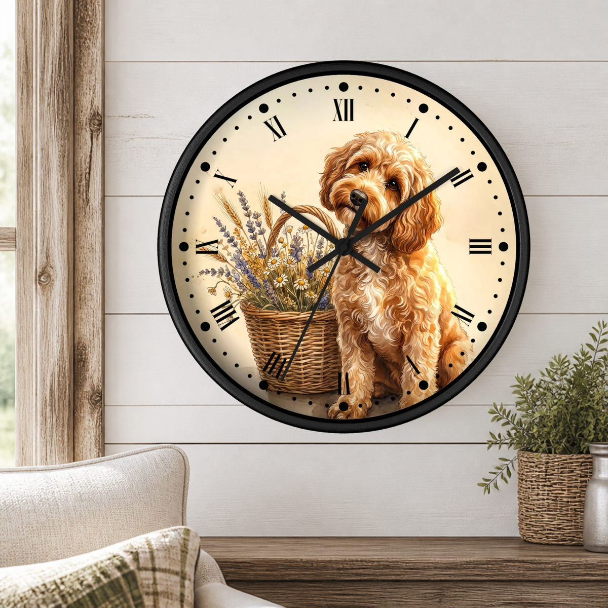 A round wall clock with a black frame and a printed design of a fluffy golden dog sitting beside a basket of dried flowers, mounted on a white shiplap wall above a wooden table with a plant.