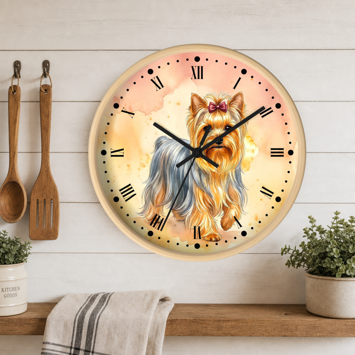 Round wall clock featuring a painted Yorkshire Terrier dog with long cream, tan, and gray fur, black Roman numerals, and black hands, mounted on a white wood plank wall above a shelf with plants and kitchen utensils.