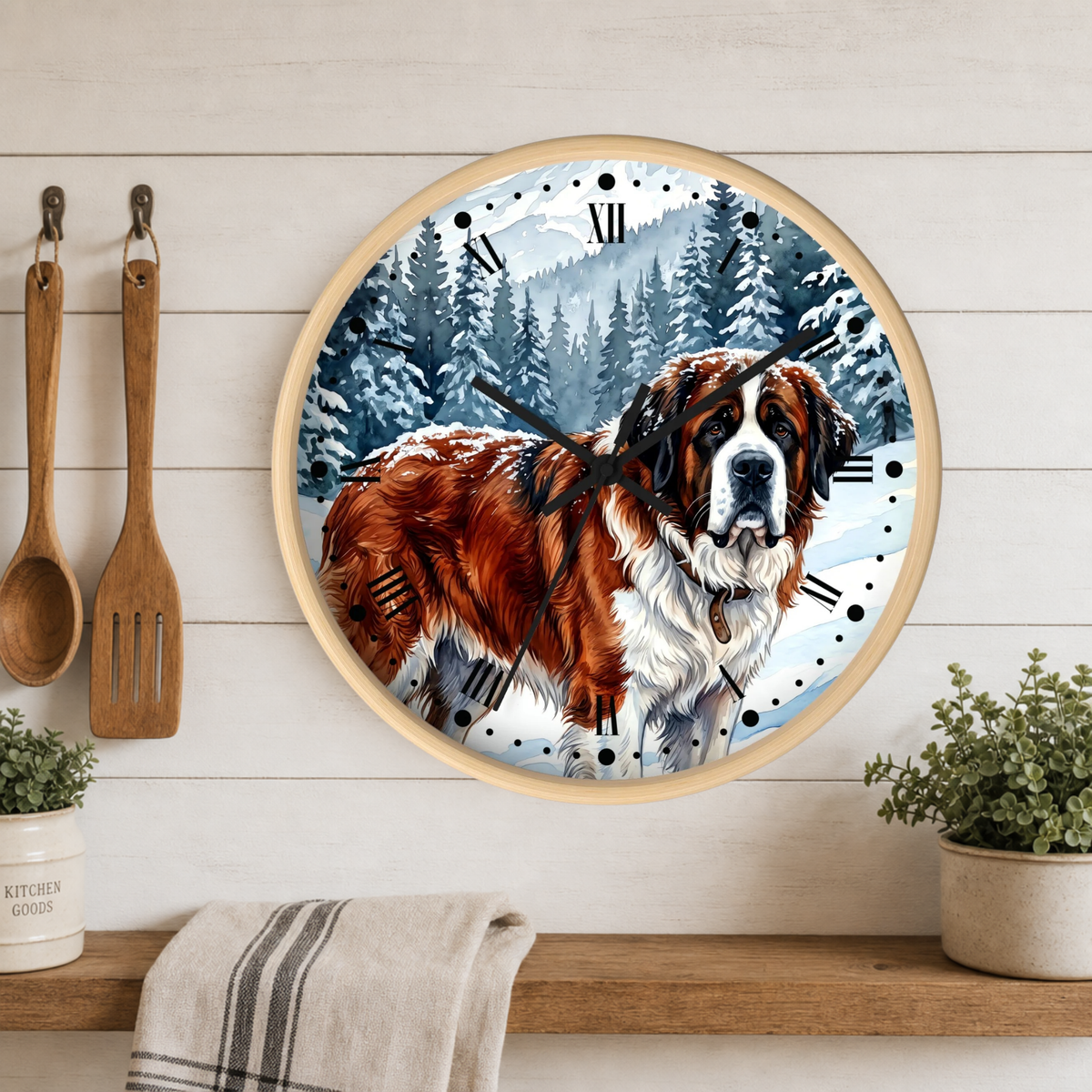 A round wall clock featuring a painted Saint Bernard dog in a snowy forest, mounted on a white wood plank wall above a wooden shelf with plants and kitchen utensils.