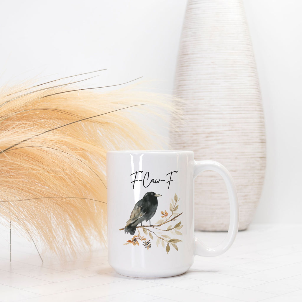 White mug with bird design and text on a light background