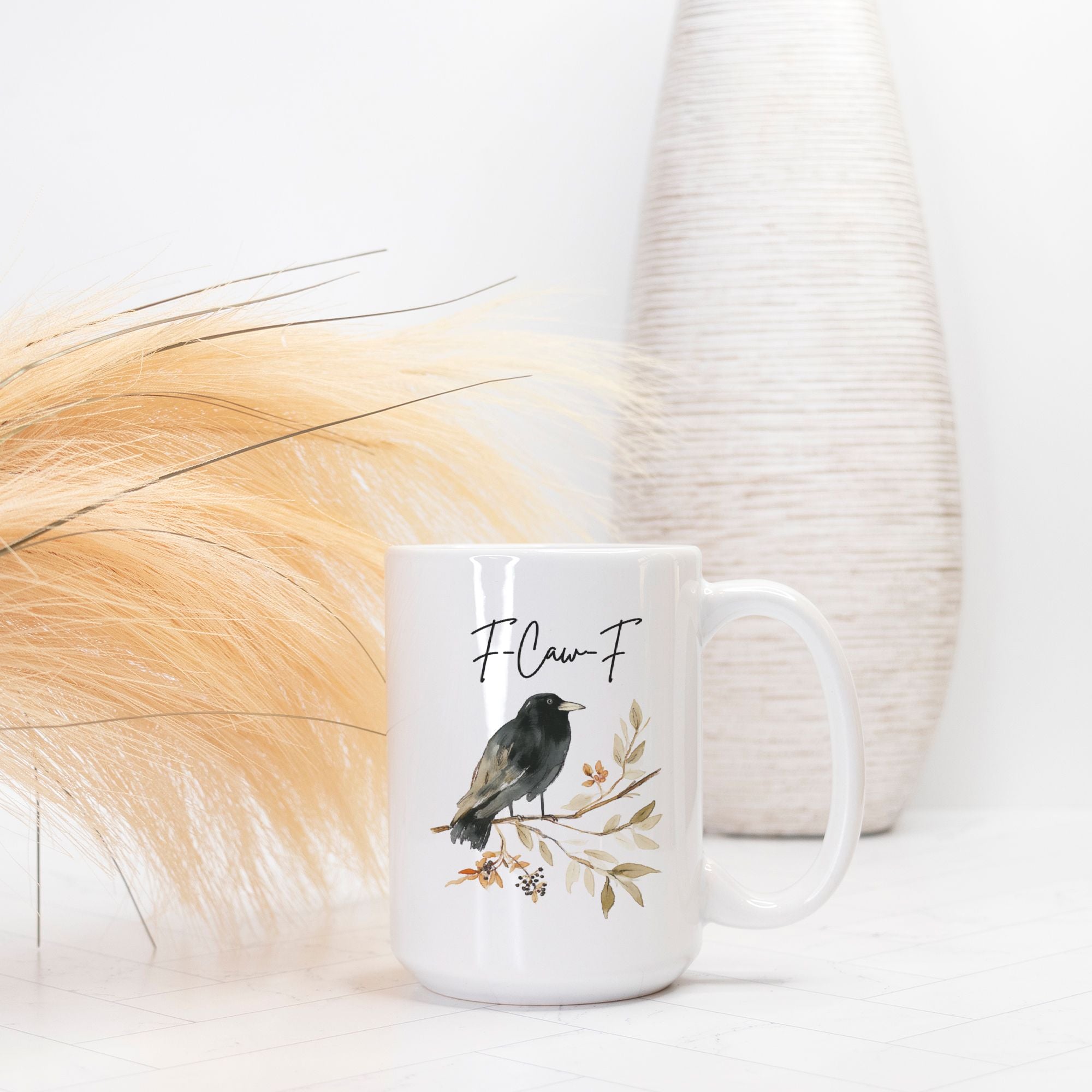 White mug with bird design and text on a light background