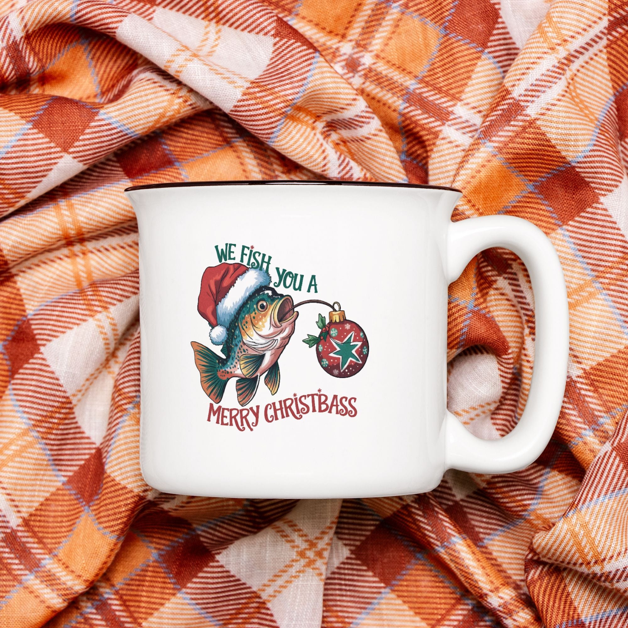 White mug with Christmas design on plaid fabric