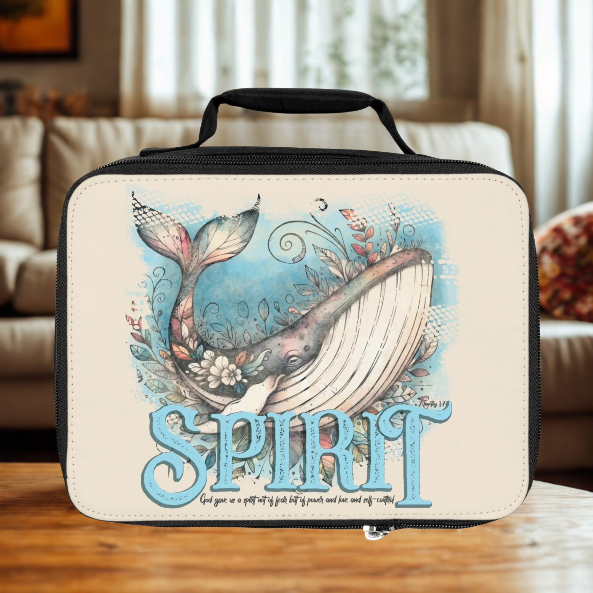  insulated lunch bag with whale design and 'Spirit' text on a wooden coffee table in a cozy living room
