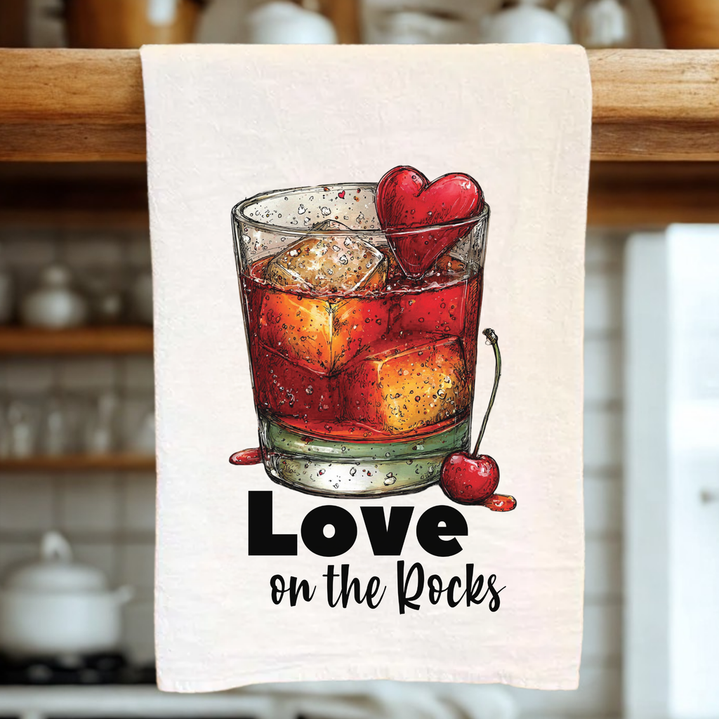 Towel with a drink illustration and 'Love on the Rocks' text in a kitchen setting