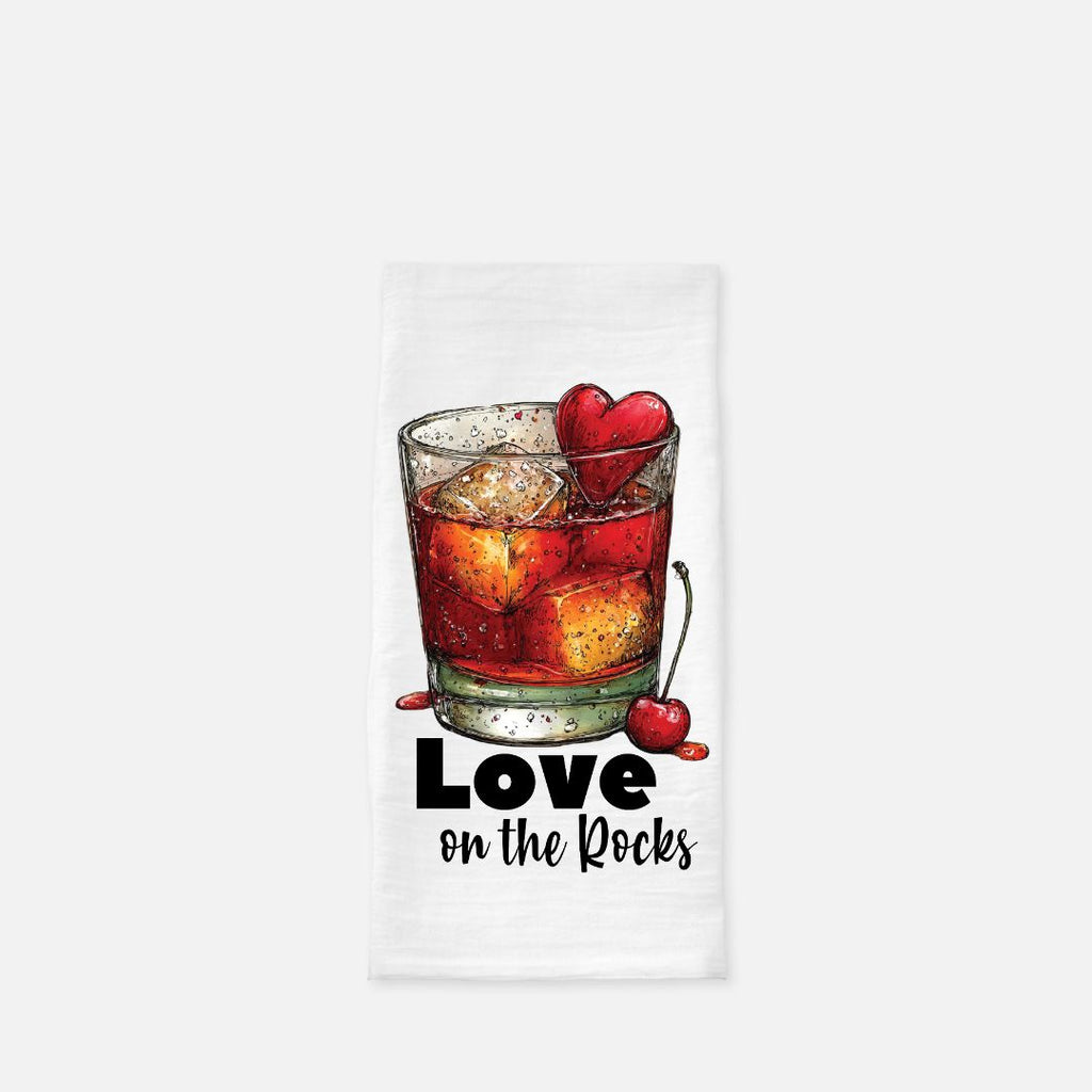 Tea towel with a glass of red cocktail with ice and cherries, and 'Love on the Rocks' text.