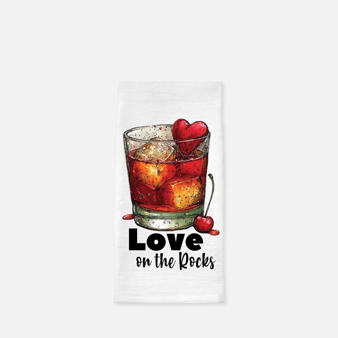 Tea towel with a glass of red cocktail with ice and cherries, and 'Love on the Rocks' text.