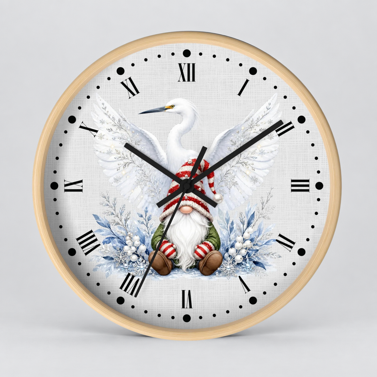 Round wall clock with a light wood frame and a white face featuring a white heron, a gnome in red and green striped clothing, and blue winter floral accents, shown on a light gray background.