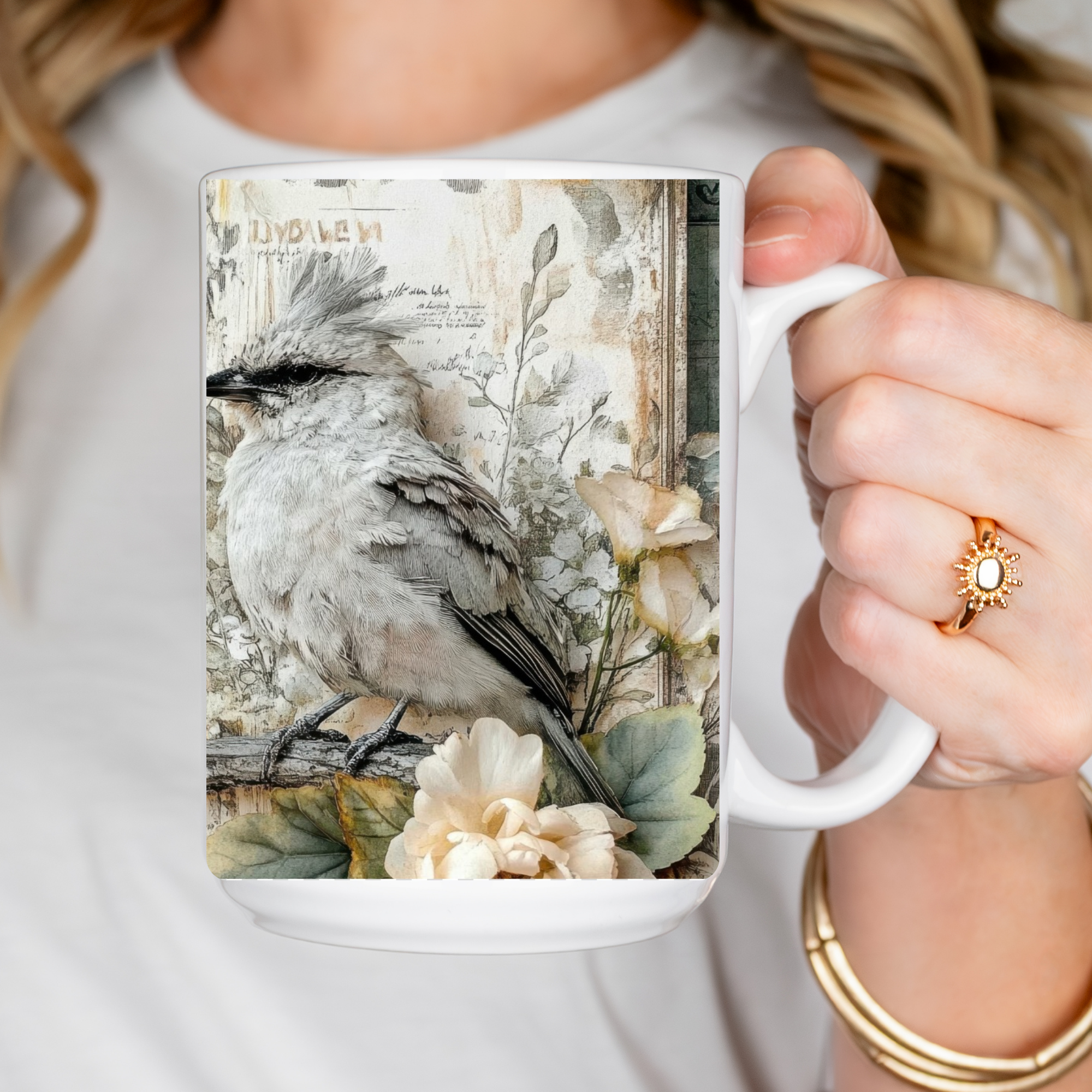 Person holding a mug with a bird design on a white background