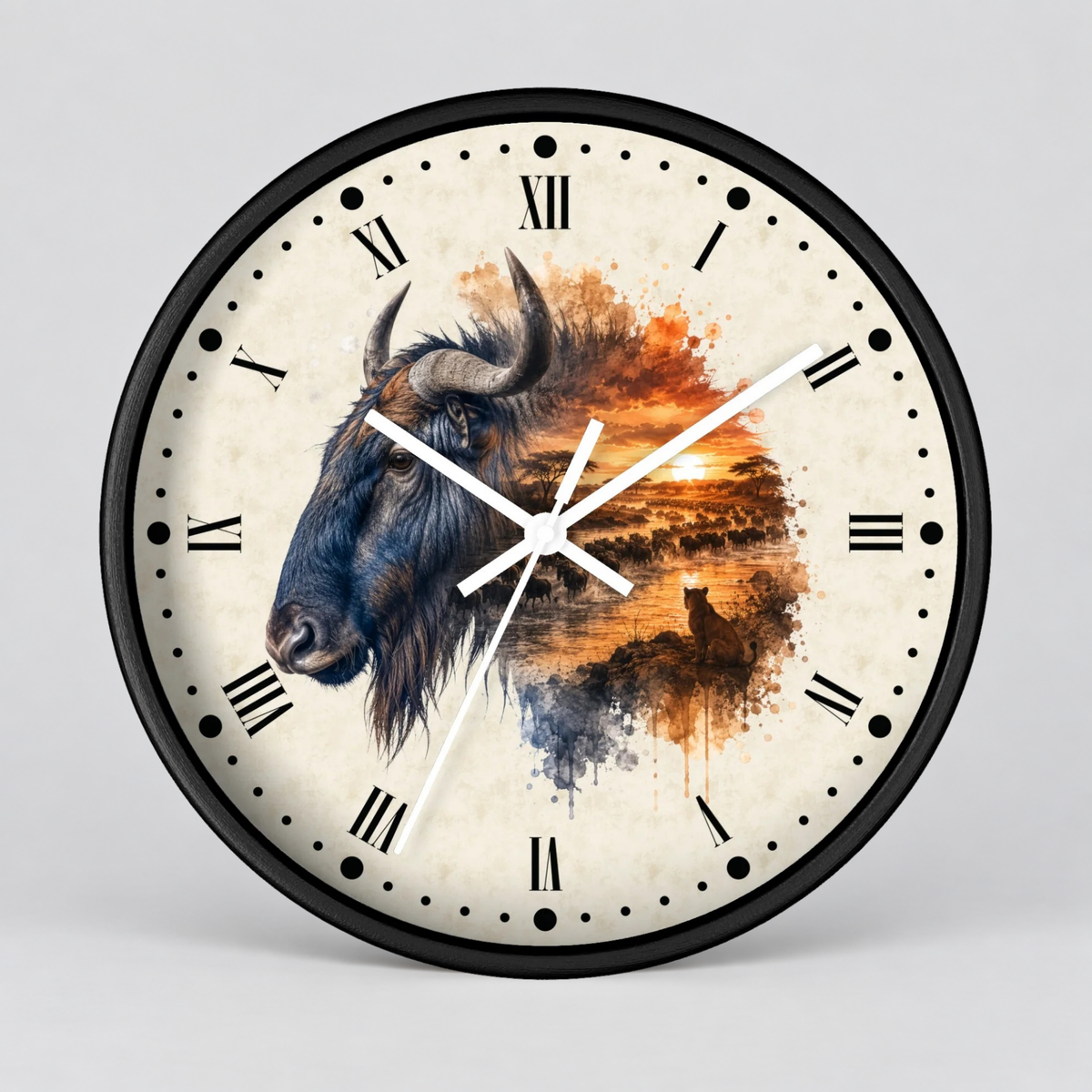 A round wall clock with a black frame and Roman numerals, featuring a split design: one half shows a detailed bison head, and the other half shows an orange sunset landscape with a lioness sitting in the grass beneath a sunset. The clock hands are white, and it is photographed against a neutral light gray background.