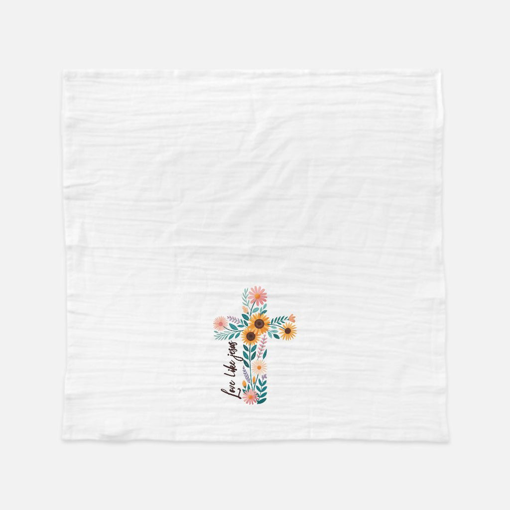 Unfolded tea towel with a Floral cross design on a white background
